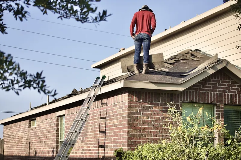Professional roofer working on a residential roof in Fortson